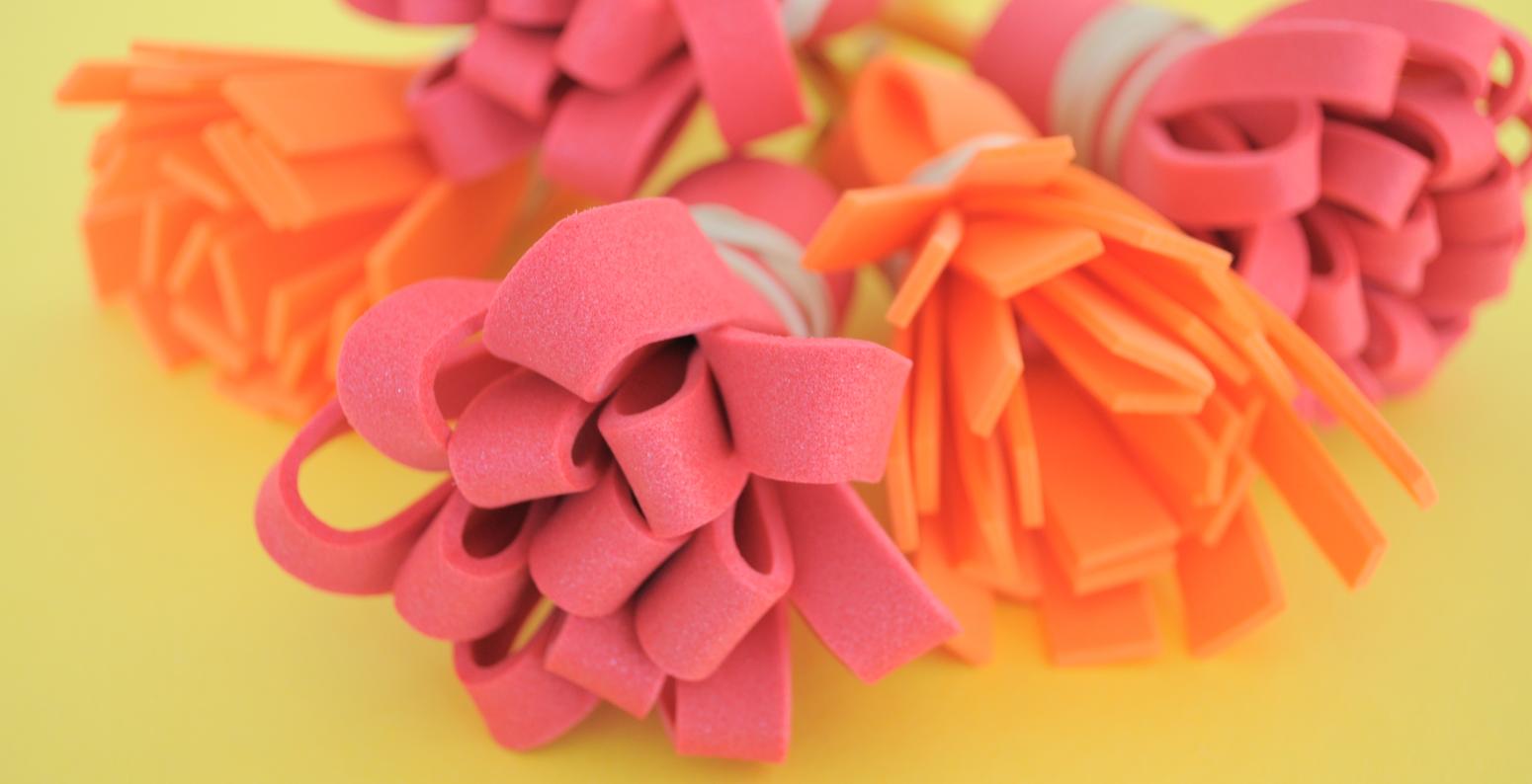 A colorful pile of paintbrushes with the bristles made from cut foam strips.