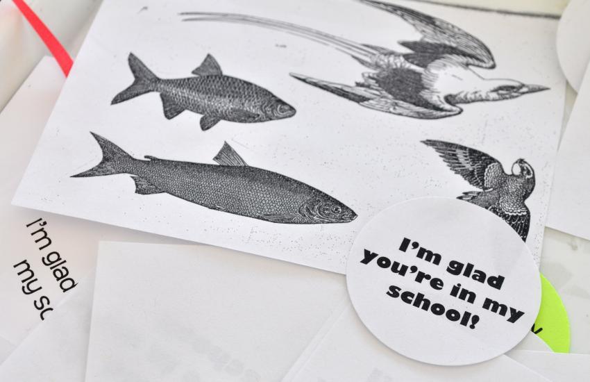 A stack of clip art images of fish and birds alongside the printed phrase "I'm glad you're in my school!". 
