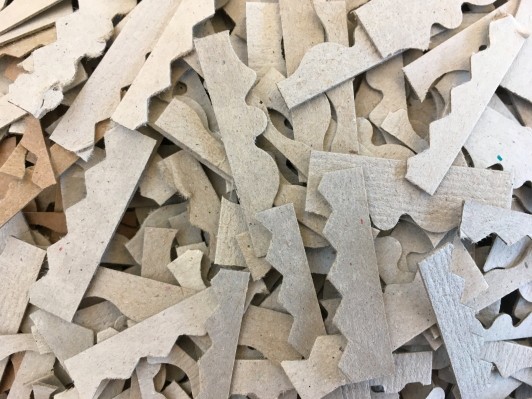 Small cardboard pieces with shaped edges.