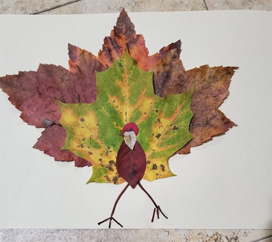 Collage bird made of layered leaves.