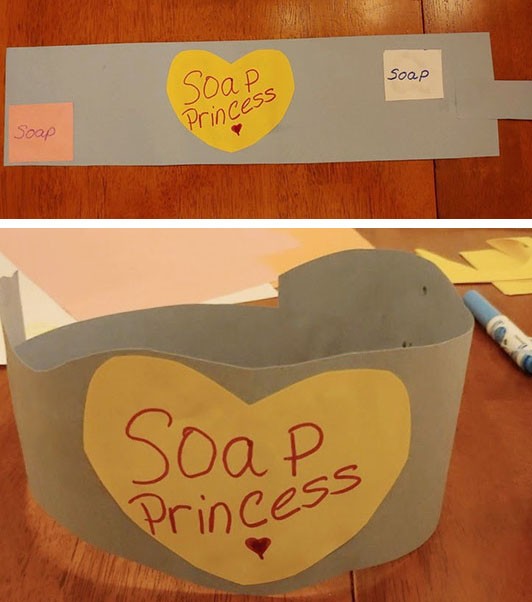 A rectangular piece of construction paper with a cut-out heart glued to it with the words "soap princess".