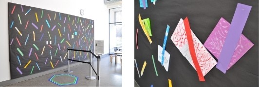 Two images of a black display wall with colorful paper strips holding square books in place.