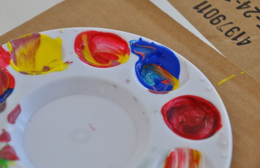 Close-up on mixed paints within paint wells.