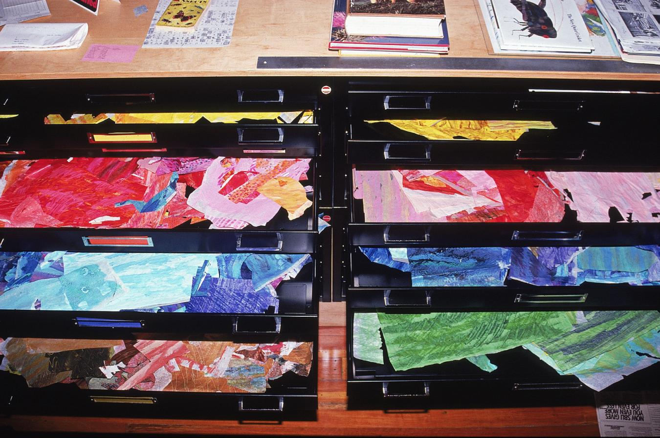 open flat files with painted tissue papers in each drawer