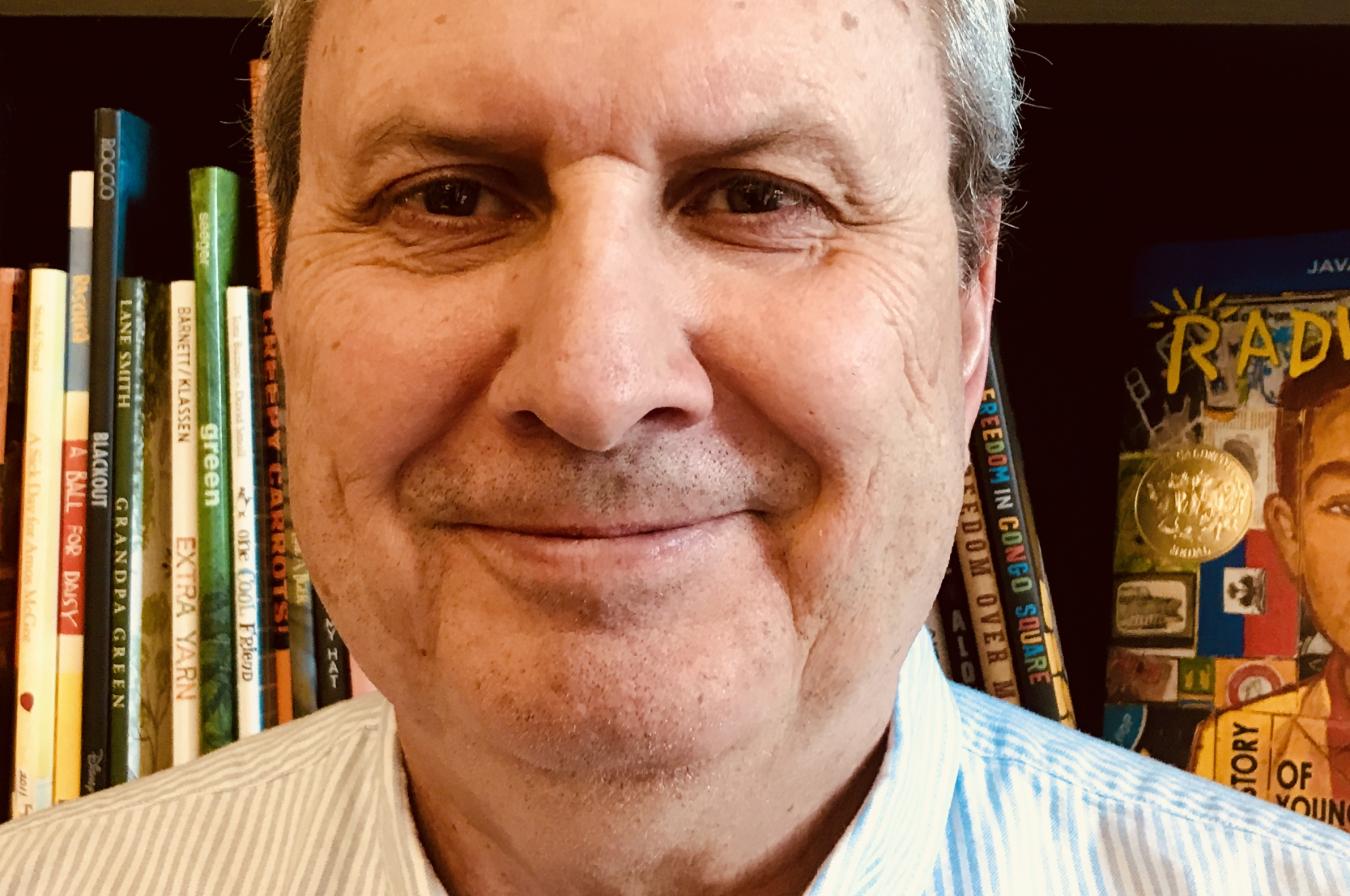 Carle Lennerz head shot with a bookcase in the background