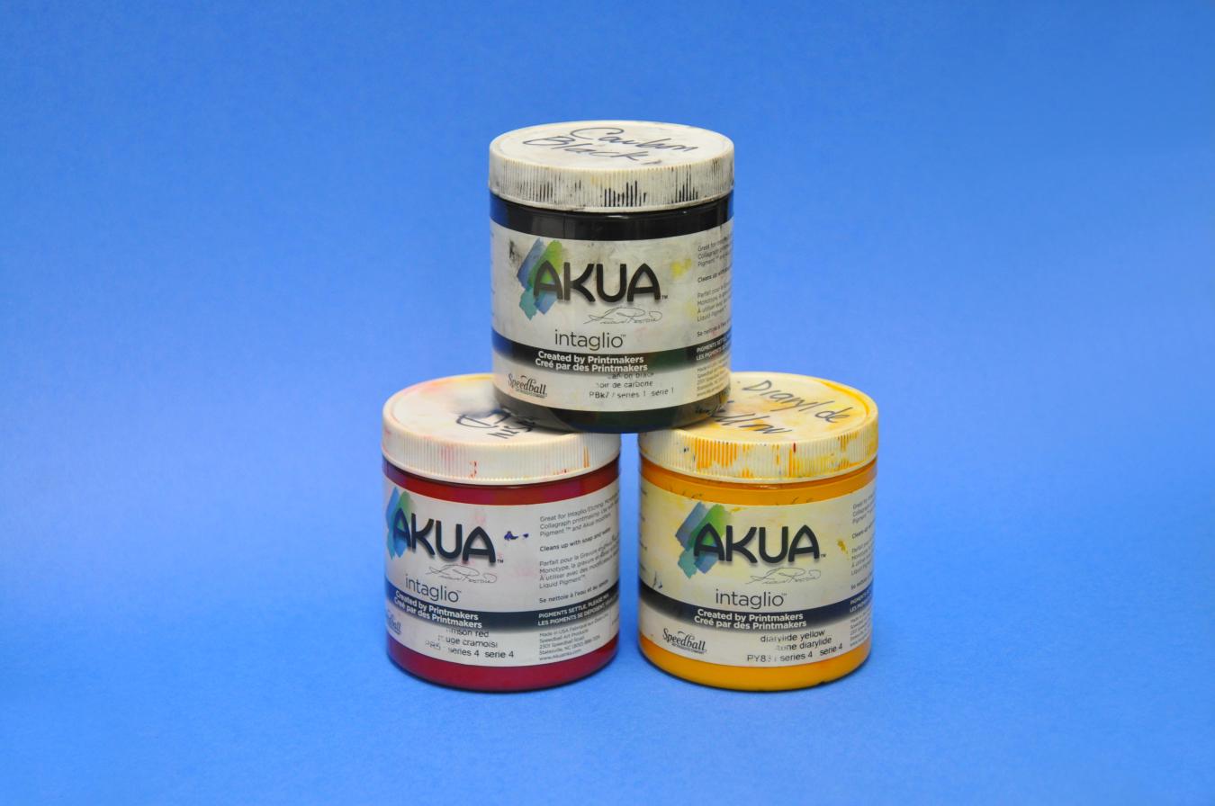 A stack of three bottles of Akua printmaking inks.