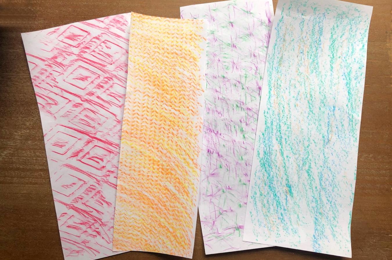 Four papers with different texture rubbings including red diamonds and orange chevrons.