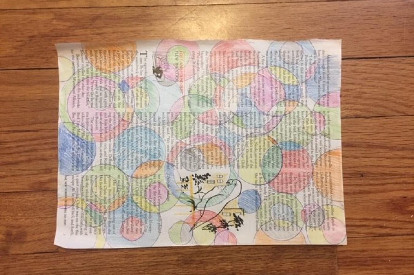 A magazine paper covered in drawn circles and shaded colors.