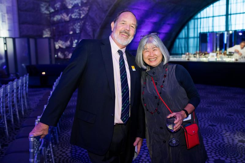 Chris Milne and Motoko Inoue smile as they stand together inside Guastavino's