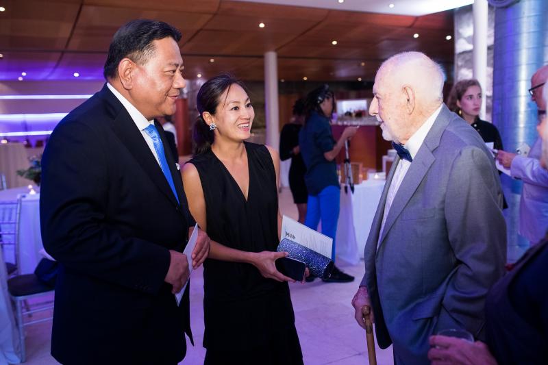 Jim Chang and Tiffany Chang smile as they talk with Eric Carle