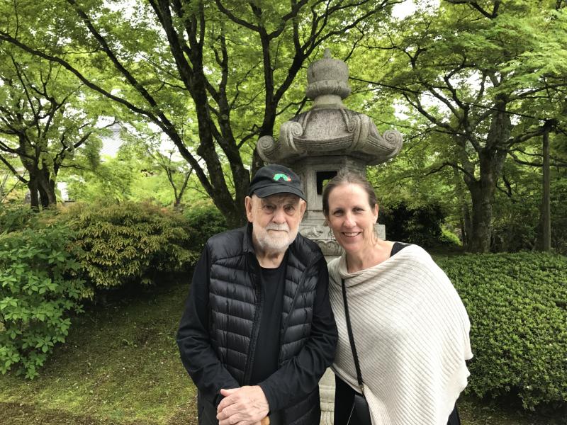 Photograph of two people standing in front of sculpture garden.