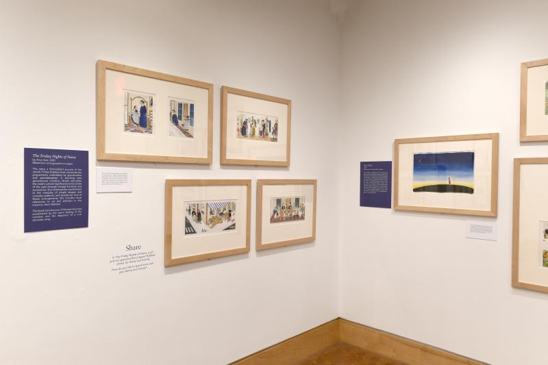 Photograph of gallery showing framed art and graphics.