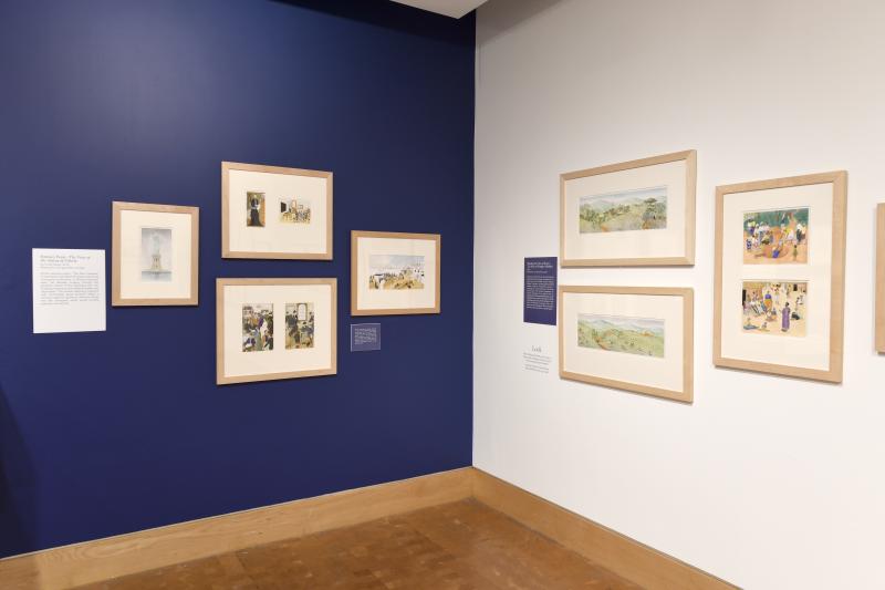 Photograph of gallery showing framed art and graphics.