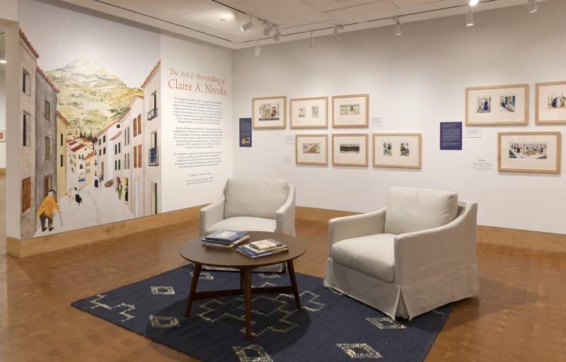 Photograph of gallery showing framed art and graphics.