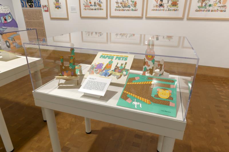 Photograph of gallery showing framed art and graphics.