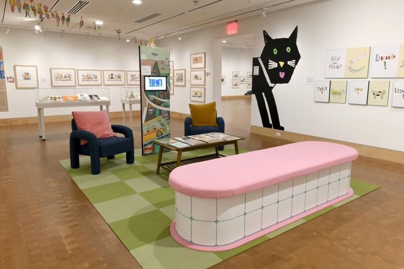 Photograph of gallery showing framed art and graphics.