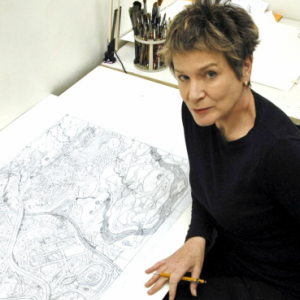 Roxie Munro in studio with drawing. 