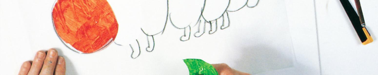 Red oval tissue paper with tracing paper caterpillar drawing and hand holing cut green tissue paper