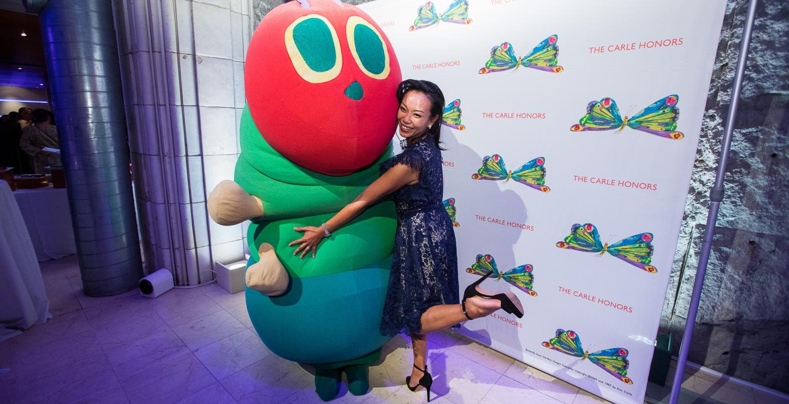 Carle Honors guest hugging the costumed Very Hungry Caterpillar 