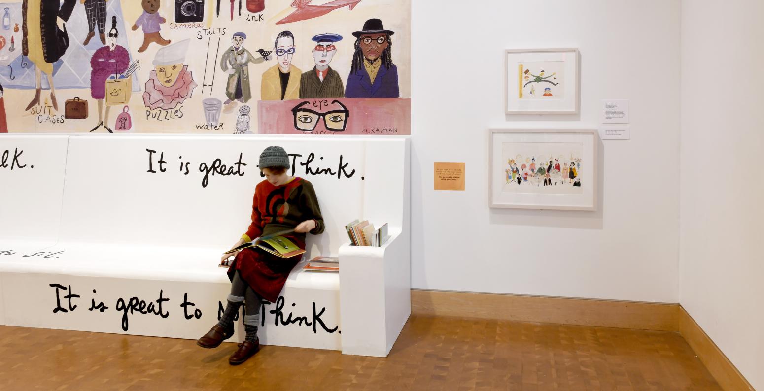 Installation image from Maira Kalman exhibition showing bench painted with text "It is great to think."