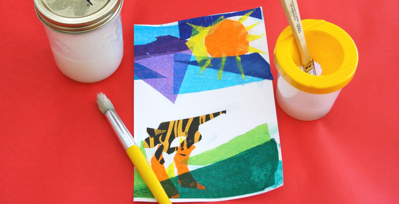 A tissue paper collage of an animal in a landscape with a Ball jar of glue, two paintbrushes, and a no-spill cup.