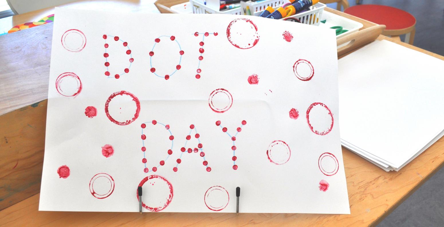 A sign made from red dots saying "Dot Day"