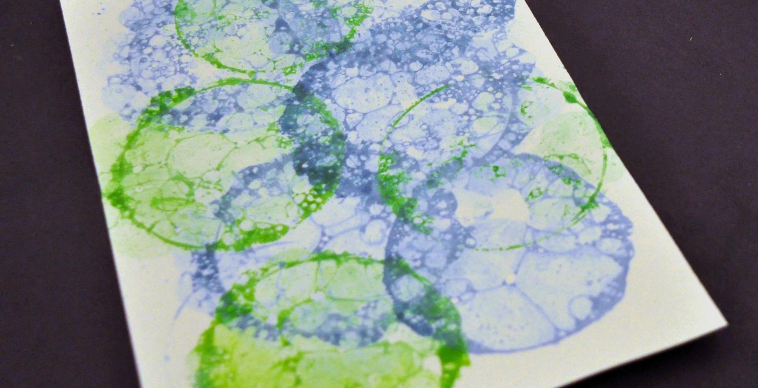 A white paper with blue and green bubble prints.
