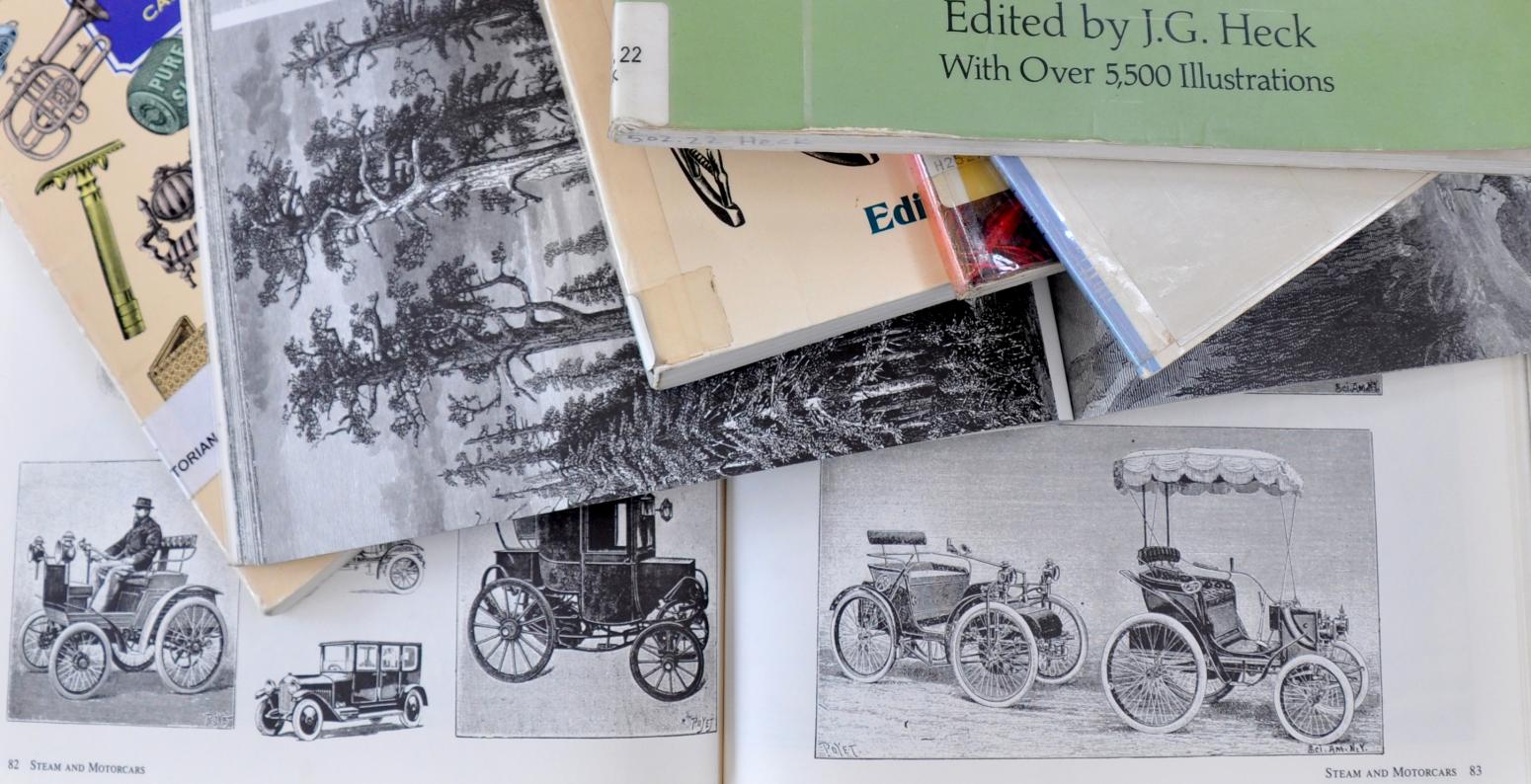 A stack of clip art books with transportation vehicles, landscapes, and animals.
