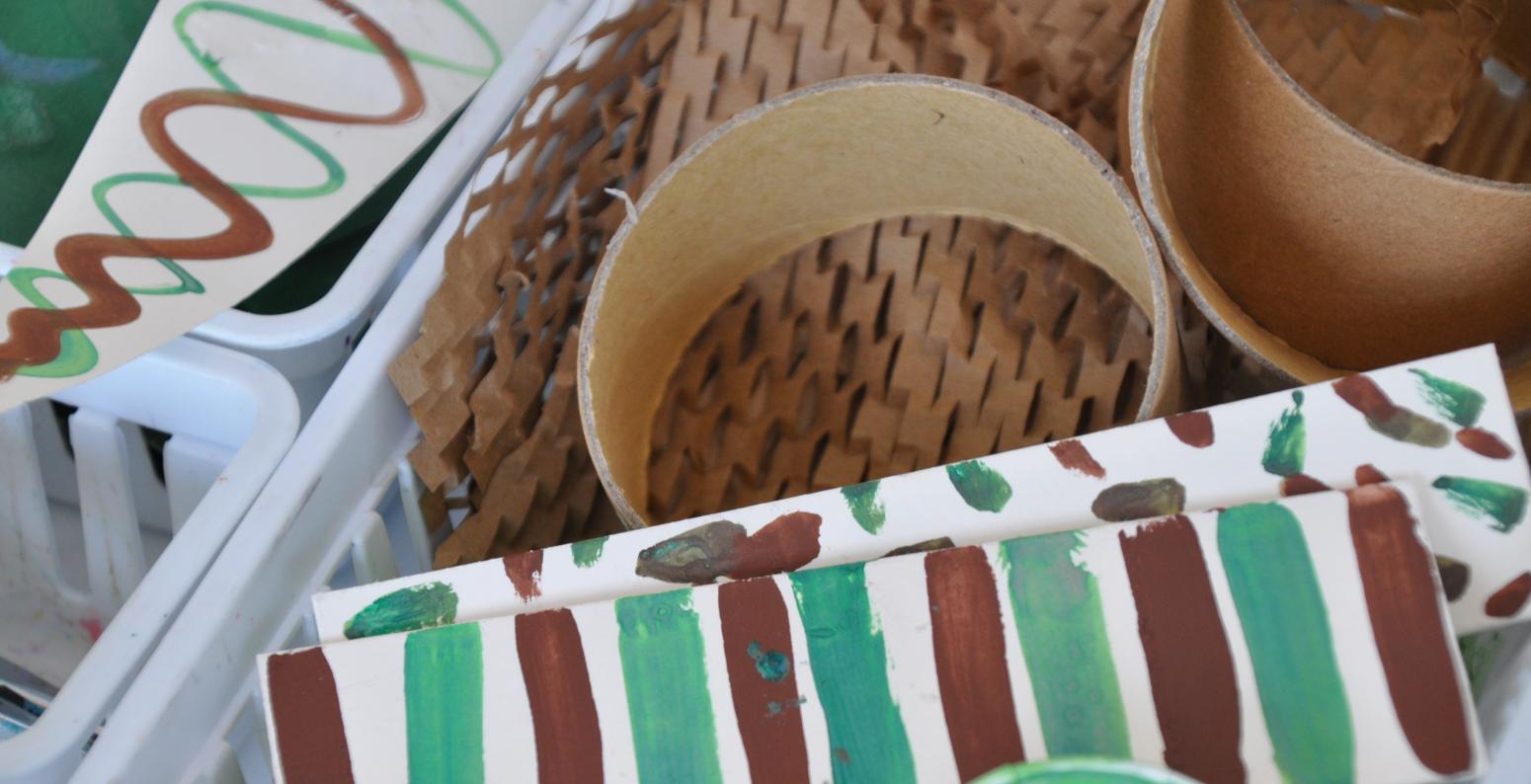 A basket of green and brown paper materials.