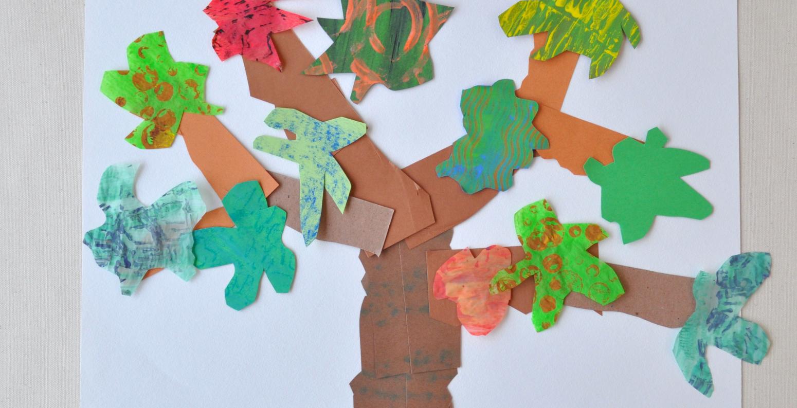 A picture of a tree made out of brightly colored and textured collage papers.