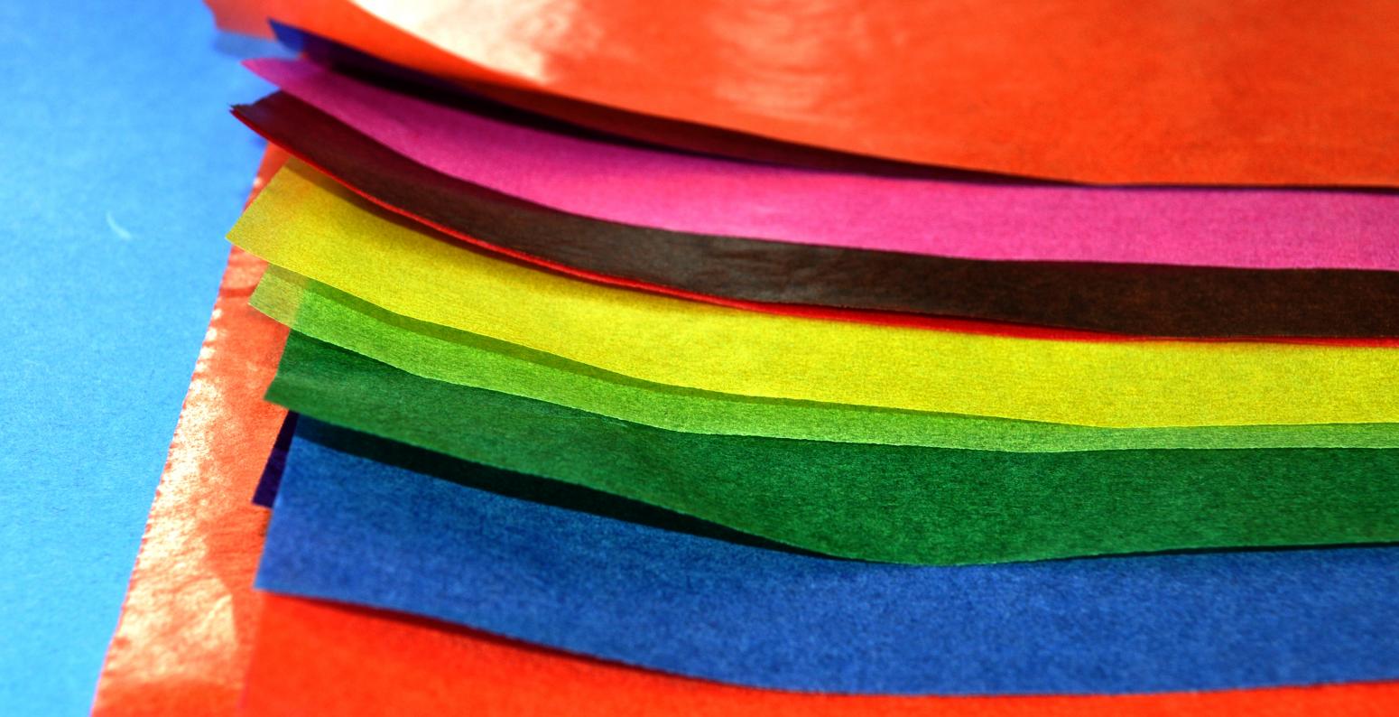 A stack of colorful, waxy Folia Transparent papers.