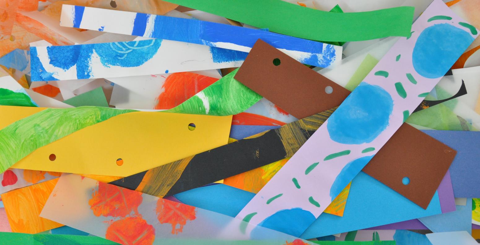 A colorful collection of brightly colored and textured collage paper strips.