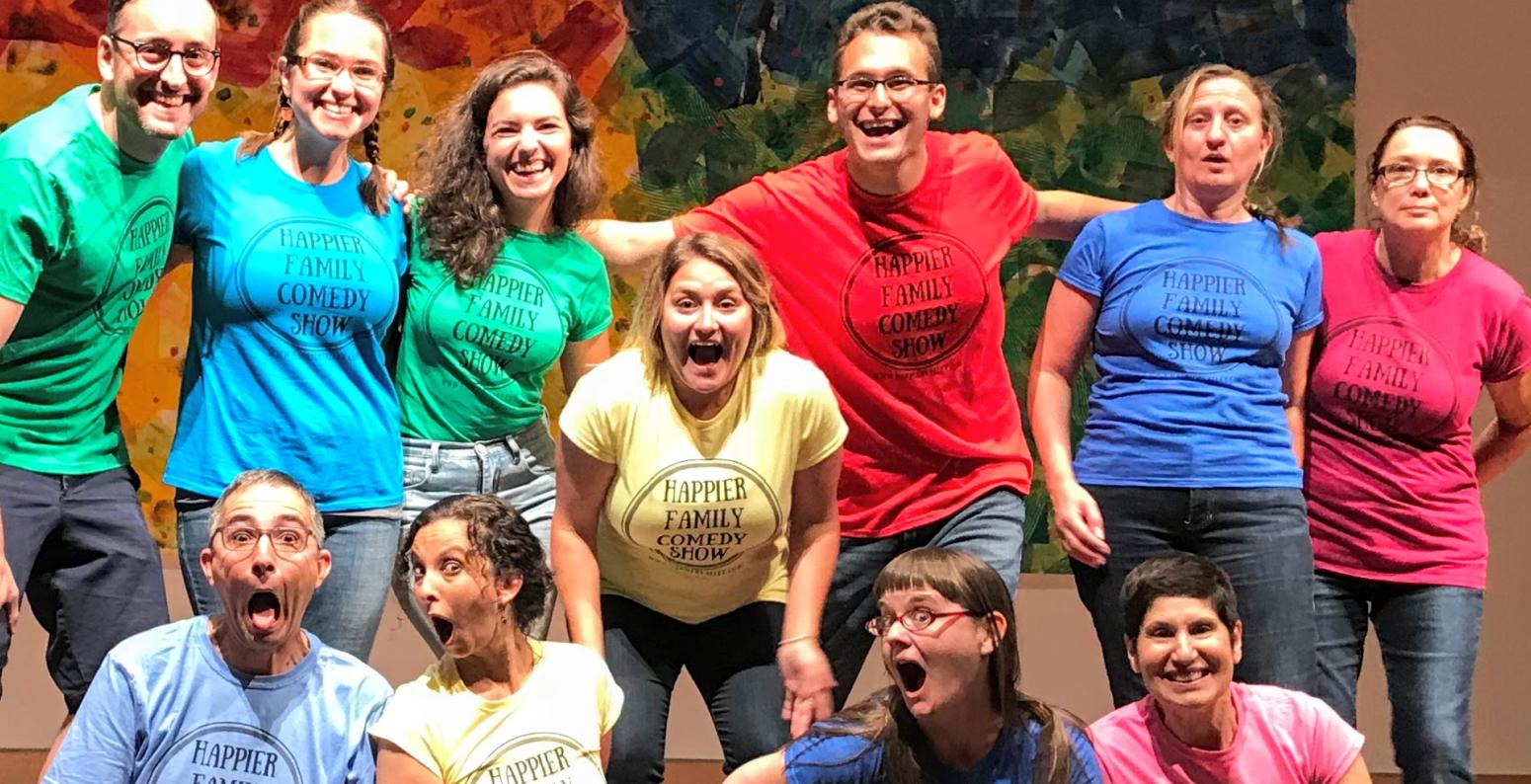 Happier Family players on stage in an assortment of colored T-shirts