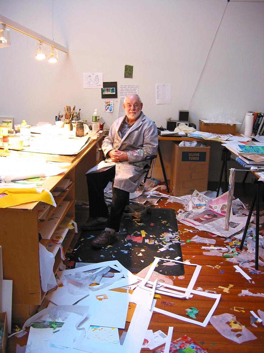 Eric Carle in his studio with cut papers. 