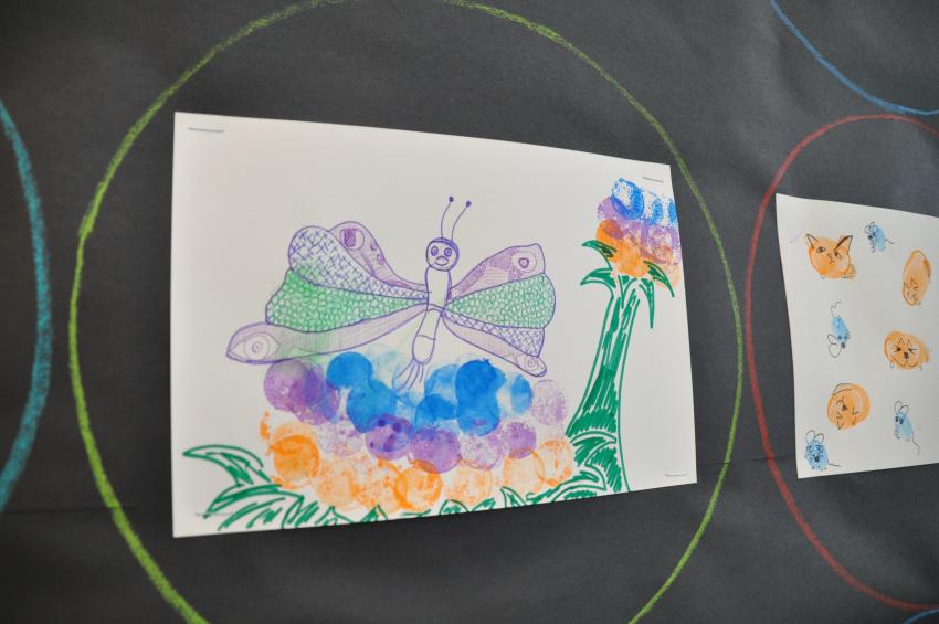 A stamp drawing of a butterfly and flower