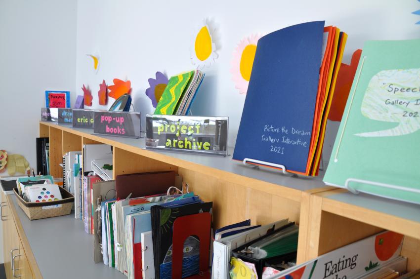 Art Studio bookshelf with books on display and subject heading signs.