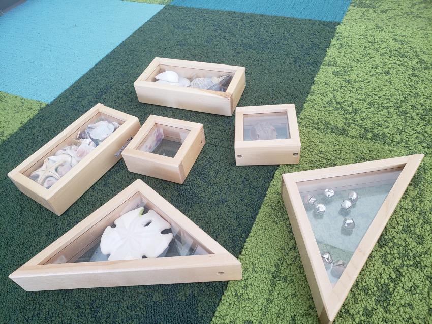 A collection of acrylic display blocks with various objects inside.