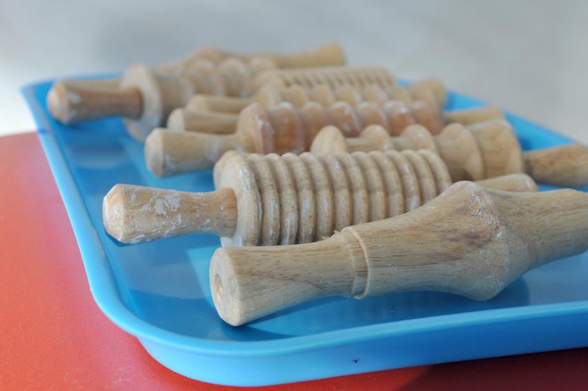 A line of rolling pins with various textures lined up on a blue tray.