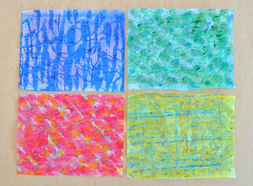 Four colorful papers created using watercolors and crayon rubbings.