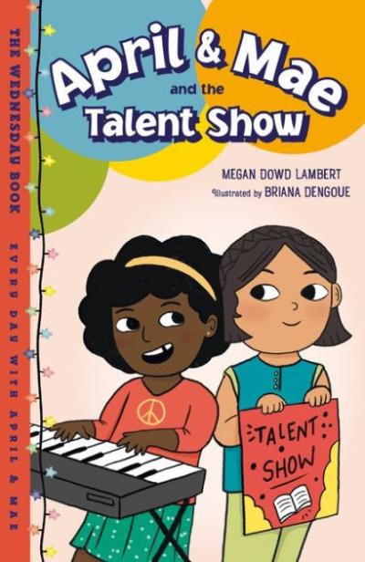 One girl plays the keyboard and another holds up a Talent Show sign.