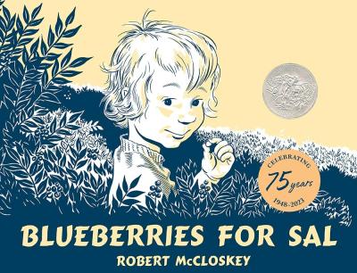 A child stands up to their shoulders in blueberry bushes holding a blueberry to their mouth.