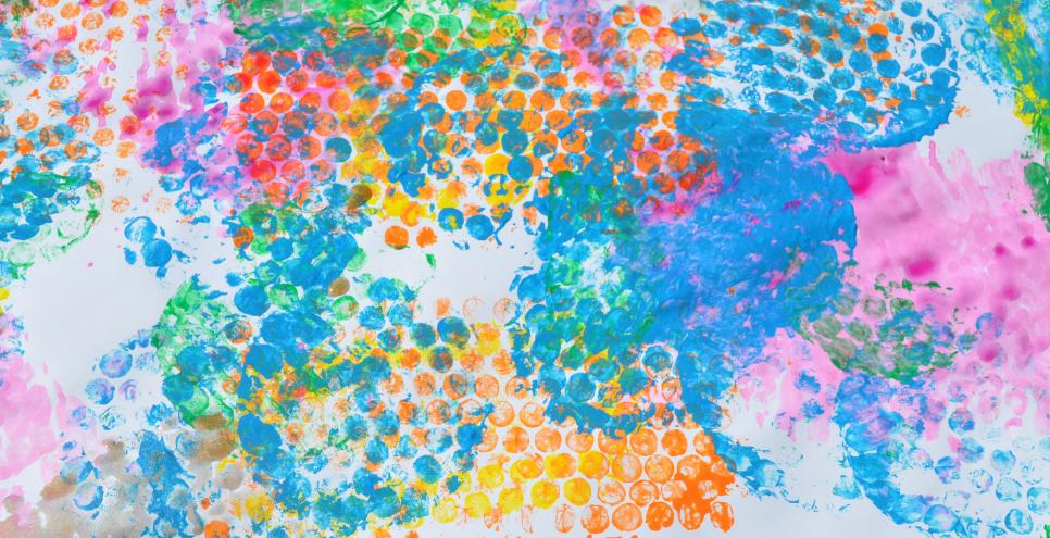 A white paper covered in colorful, bubble-wrap-stamp imprints.