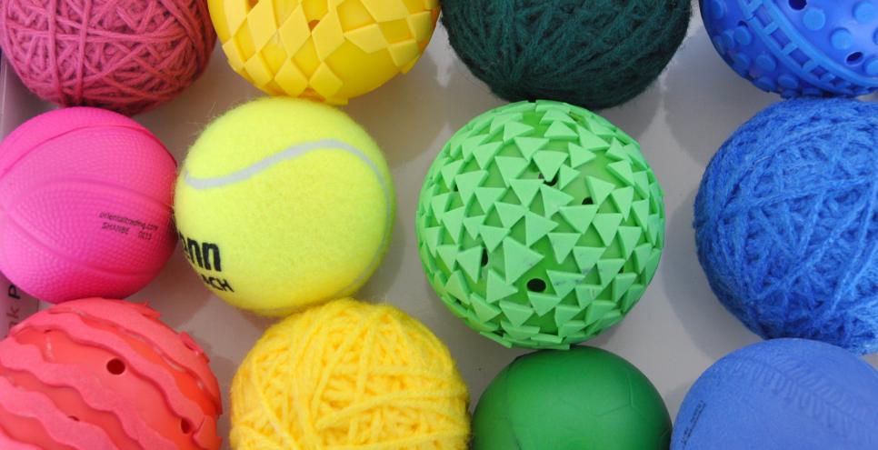 Twelve brightly colored balls with various textures attached to them to use in printmaking.
