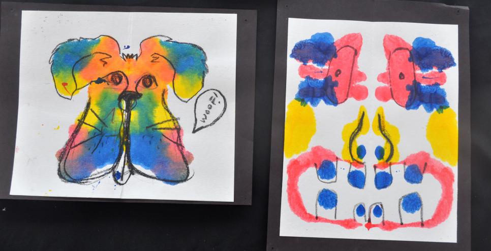 Two inkblot creatures painted with mirror image printmaking using liquid watercolor and drawing tools.