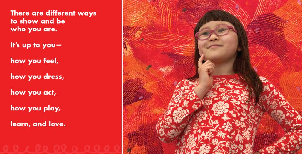 Young girl in red and white floral shirt stading in front of a red mural.