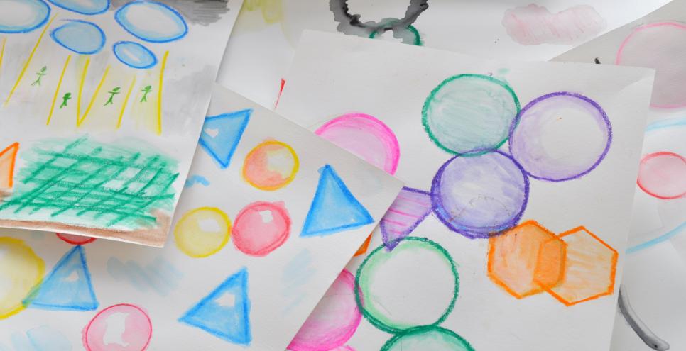 Colorful painted shapes made using watercolor pencils.