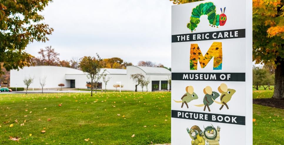 The Eric Carle Museum sits in the background with it's sign in the forefront.