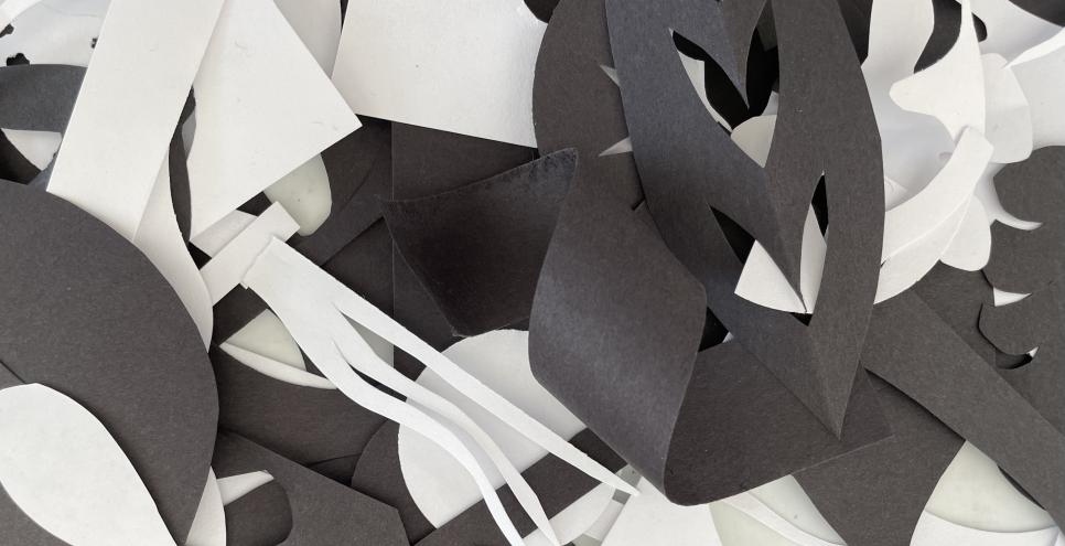 A close up of black and white paper cut outs