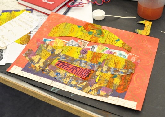 An artwork where the word "Treasures" is written on a collage paper then glued to a larger collage of a treasure box filled with stamps.