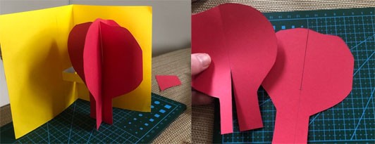 Two images showing a yellow pop-up card with a red tree. The image to the right shows two red silhouettes of a tree, each with a cut in the middle that allows them to be notched together. The image to the right shows the card assembled where the tree is glued to the cut-out pop-up on the yellow card.